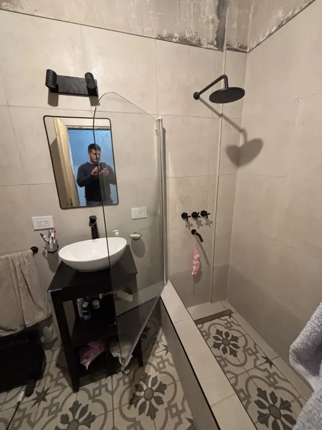 Baño remodelado con ducha y piso calcáreo
